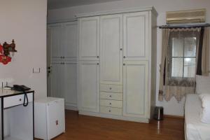 A bed or beds in a room at Konak Hotel Tuzla