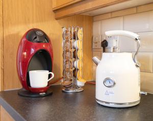 a red and white coffee maker sitting on a counter at Finest Retreats - Berry Cottage - 4 Bedroom, Pet-Friendly Cottage Sleeping 8 in Eglwyswrw