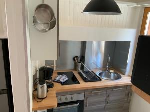 a kitchen with a counter with a sink and a stove at Villa Georges in Le Tréport +9 photos
