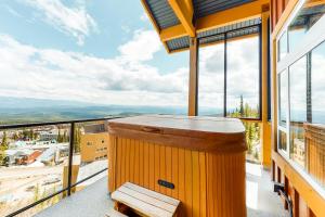 a wooden bar on the balcony of a house at Timber Ridge in Big White
