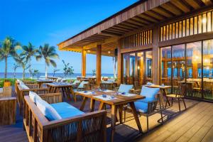 a restaurant on the beach with tables and chairs at Alma Resort Cam Ranh in Cam Ranh +53 photos