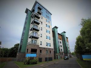 a tall apartment building on the side of a street at The Lochend Residence in Edinburgh