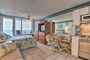 a bedroom with a bed and a desk in a room at Oceanfront Daytona Beach Studio with Balcony in Daytona Beach Shores