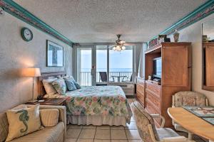 a bedroom with a bed and a couch and a table at Oceanfront Daytona Beach Studio with Balcony in Daytona Beach Shores