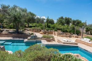 a swimming pool in a garden with trees at Villa Delle Palme in Trepuzzi