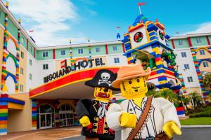 a man dressed in a pirate costume and holding a teddy bear at LEGOLAND® Florida Resort in Winter Haven
