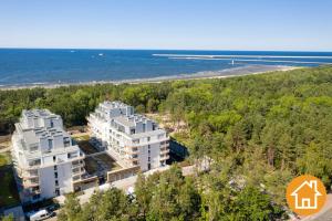 an aerial view of two white buildings next to a beach at Apartamenty ApartPark - visitopl in Świnoujście