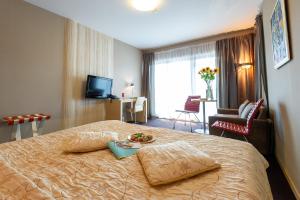 Postel nebo postele na pokoji v ubytování Niebieski Art Hotel & Spa