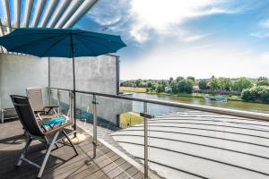 
a patio area with an umbrella and chairs at Niebieski Art Hotel & Spa in Krakow
