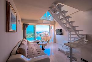 a living room with a couch and a spiral staircase at Apartments Dilberovic in Dubrovnik