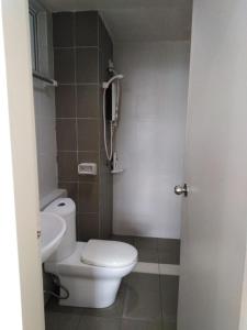 a bathroom with a white toilet and a sink at Ziehass Homestay D'Perdana Apartment in Kota Bharu