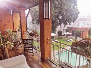 a balcony with a view of a pool at Maison d'Hôtes Mandrosoa in Antananarivo