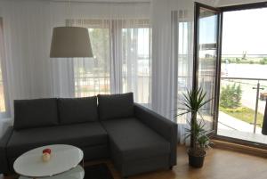 a living room with a couch and a table at Apartament Panorama in Tczew