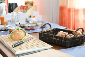 a table with a basket of bread and a knife at hotel löwen in Niederuzwil