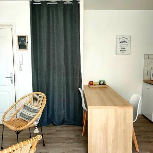 a room with a table and chairs and a curtain at STUDIO ENTRE PLAGE ET PORT in Les Sables-d'Olonne +5 photos