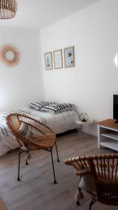 a bedroom with a bed and a chair and a table at STUDIO ENTRE PLAGE ET PORT in Les Sables-d'Olonne