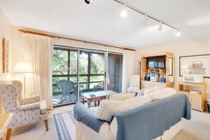 a living room with a blue couch and chairs at Mariner's Watch 4288 in Kiawah Island