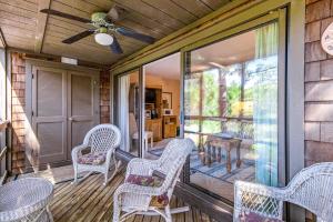 a porch with wicker chairs and a table at Mariner's Watch 4288 in Kiawah Island