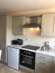 a kitchen with a black and white stove top oven at Queen Street Apartments in Enniskillen