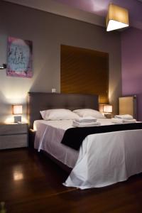 a hotel room with two beds with white sheets at Βright Walled Designed Apt in Glyfada Center in Athens