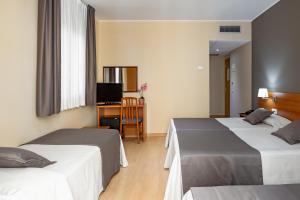 Säng eller sängar i ett rum på Catalunya