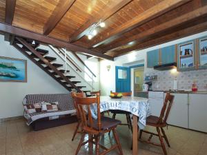 a kitchen and living room with a table and chairs at House Peroj 705 in Peroj