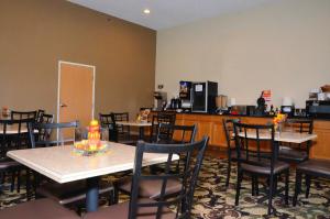 a dining room table and chairs in a restaurant at Cobblestone Inn & Suites - Lake View in Lake View