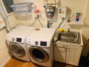 a washing machine and a sink in a room at Historical Neighborhood Home in New Rochelle +35 photos