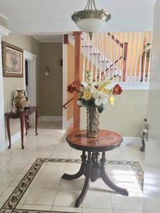 a vase of flowers on a table in a room at Historical Neighborhood Home in New Rochelle