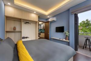 a bedroom with a large white bed and a tv at GH Apartment Westlake - Managed by Pegasy Group in Hanoi