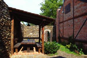 a wooden picnic table in front of a brick building at Penzion Kutna in Kutná Hora