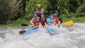 a group of people on a raft in the water at Hotel Villas Rio Mar in Dominical