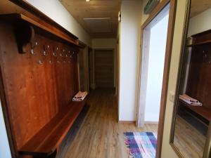 a hallway in a house with wood paneling and a door at Stoffis Hütten in Tauplitz
