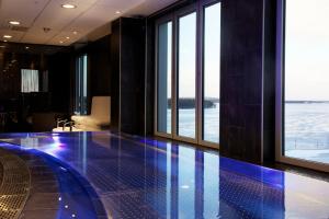 a large swimming pool in front of a large window at Clarion Hotel Sense in Luleå
