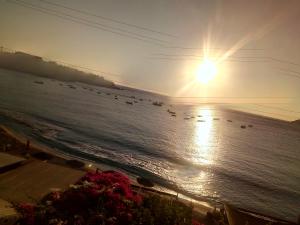 a view of a beach with boats in the water at Buganvilla Sea View apts in Agia Pelagia