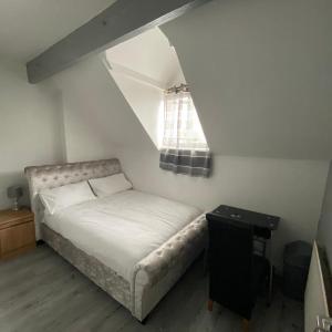 a small bedroom with a bed and a window at Glorious catering & Restaurant BnB in Ocker Hill