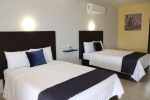 Postel nebo postele na pokoji v ubytování Hotel Jazuli