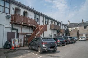 a car parked in a parking lot next to a building at The Haven Keswick - Spacious Central Apartment in Keswick