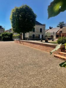 a house with a tree in the middle of a street at La maisonnée de Chambord in Crouy-sur-Cosson