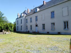 a large white house with a large yard at Chateau de Linard in Linard