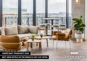 a living room with a couch and chairs and tables at Thompson Washington DC, by Hyatt in Washington, D.C.