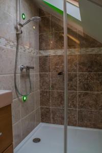 a shower with green lights in a bathroom at Reayrt Ny Marrey in Kirkmichael