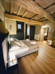 een groot bed in een kamer met een houten vloer bij Montella 2 in Spoleto