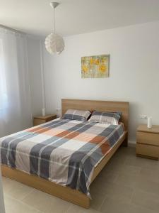 a bedroom with a bed and a painting on the wall at Mia Apartament in Tulcea