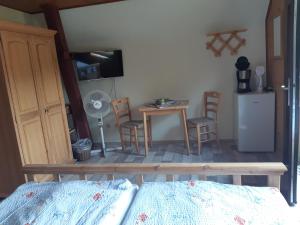 a bedroom with a bed and a table and chairs at Spreewaldpension Glatz in Müschen
