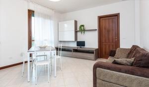a living room with a couch and a table at Apartment Via delle Torri in Pisa
