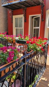a balcony filled with lots of flowers on a building at Faik Pasha Hotels Special Category Beyoglu Istanbul in Istanbul