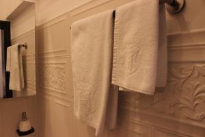 a bathroom with white towels hanging on a wall at ELLA Apartment Timisoara no11 in Timişoara