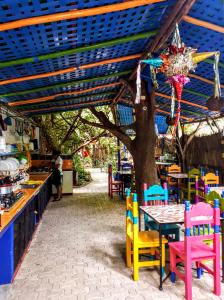 un restaurante con mesa y sillas bajo un árbol en Hostel Candelaria, en Valladolid