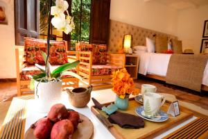a living room with a table with food on it at Hotel Casa Terra in Villa de Leyva